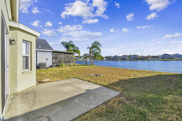 view of yard featuring a patio, a water view, central AC unit, and a sunroom