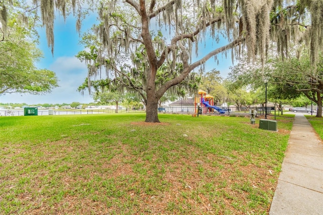 view of yard with a water view and a playground