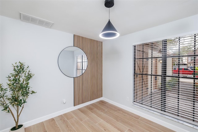 unfurnished room with wood-type flooring