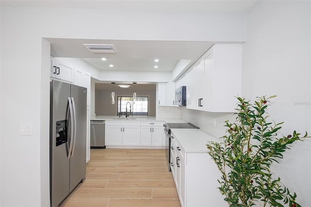 kitchen featuring white cabinetry, appliances with stainless steel finishes, and sink