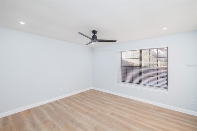 spare room featuring ceiling fan and light wood-type flooring