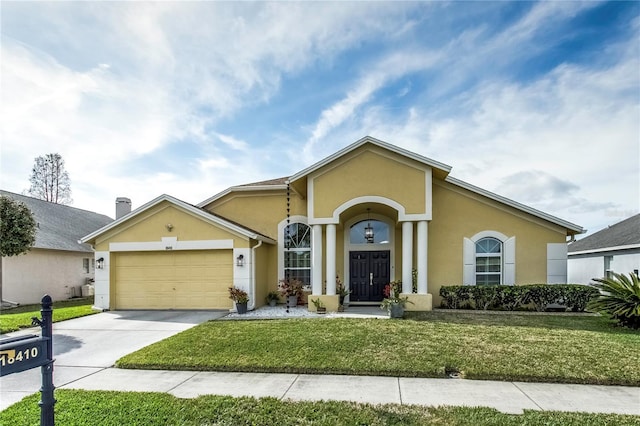 ranch-style home featuring a garage and a front lawn