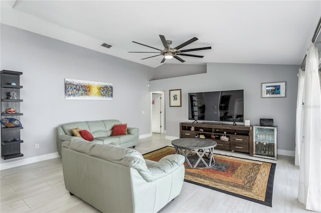 living room featuring vaulted ceiling, ceiling fan, and light hardwood / wood-style floors