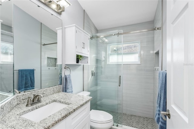 bathroom with vanity, toilet, and walk in shower