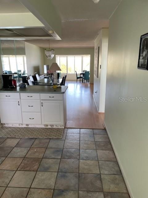 kitchen featuring plenty of natural light and white cabinets