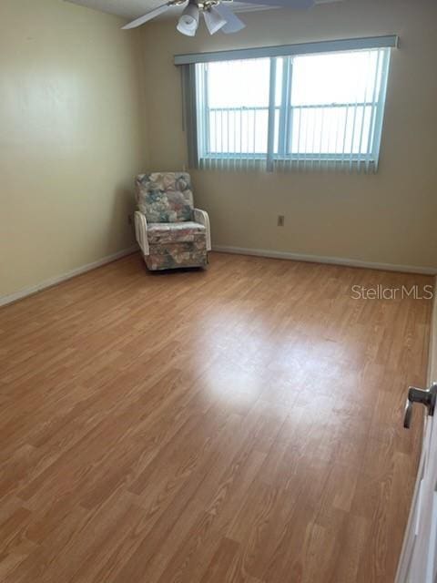 unfurnished room with ceiling fan and light hardwood / wood-style floors