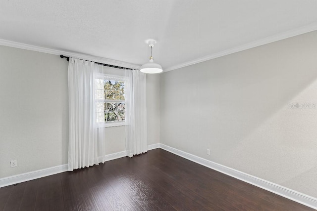 empty room with crown molding and dark hardwood / wood-style floors