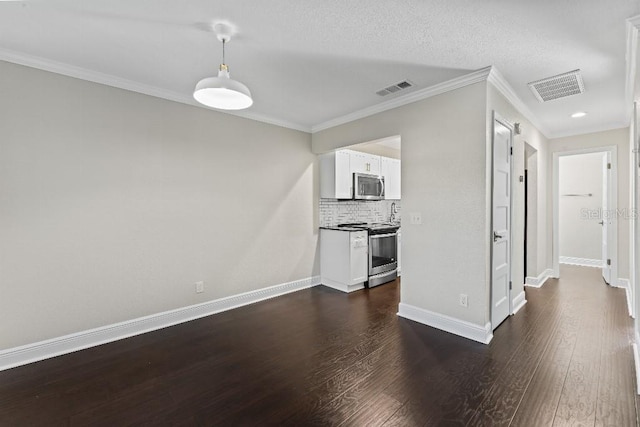 unfurnished living room with ornamental molding and dark hardwood / wood-style flooring