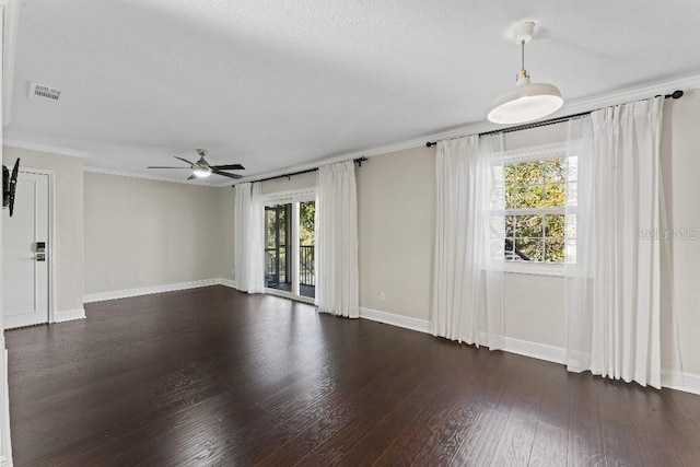 empty room featuring ceiling fan, ornamental molding, and dark hardwood / wood-style floors