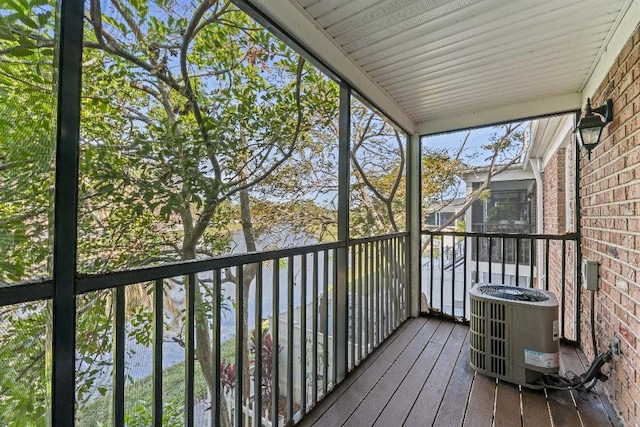 wooden deck featuring cooling unit