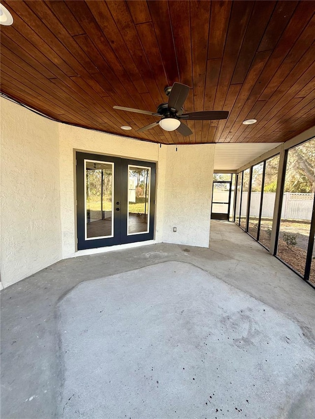 unfurnished sunroom with wood ceiling and french doors