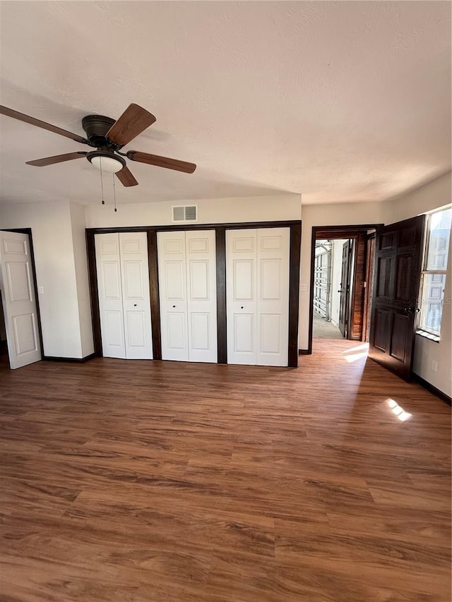 unfurnished bedroom featuring wood-type flooring and ceiling fan