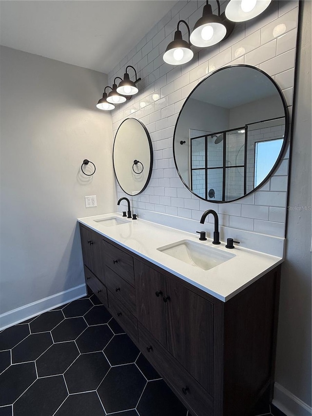 bathroom featuring vanity, tile patterned flooring, and backsplash