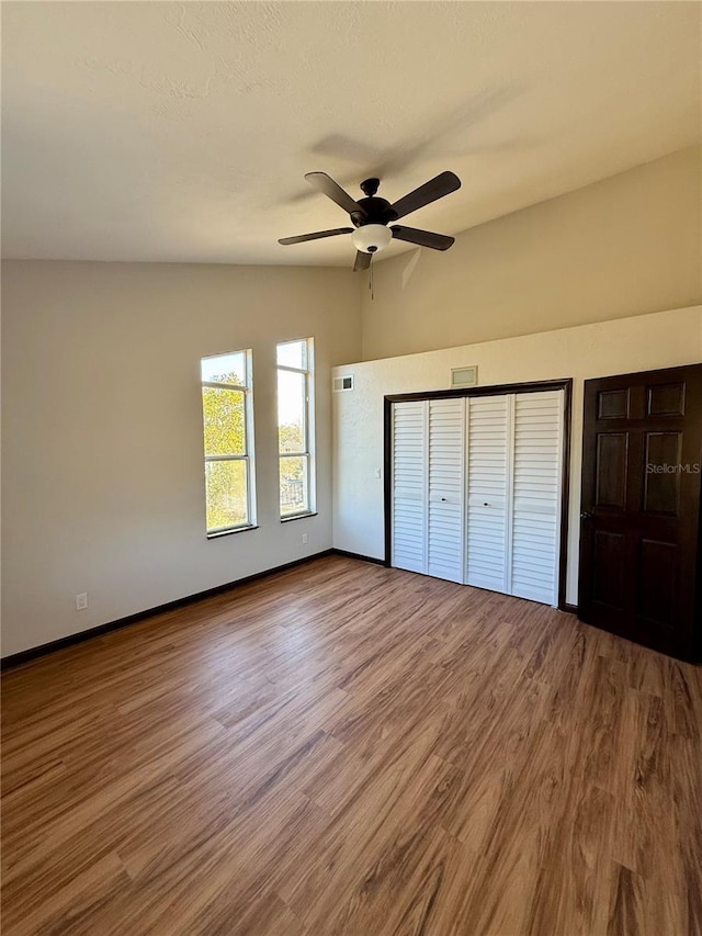 unfurnished bedroom with ceiling fan and wood-type flooring