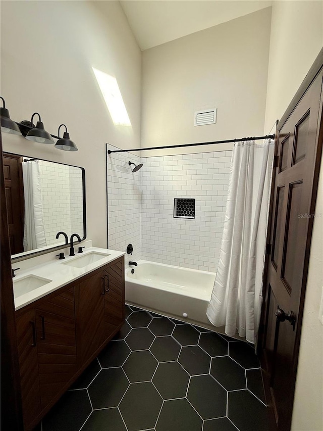 bathroom with vanity, shower / tub combo, and tile patterned floors