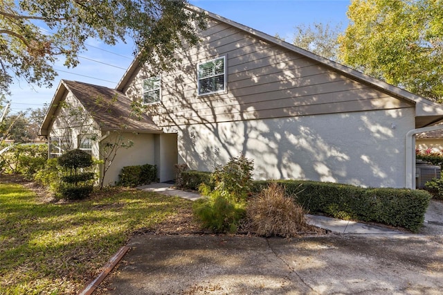 view of side of home featuring a yard