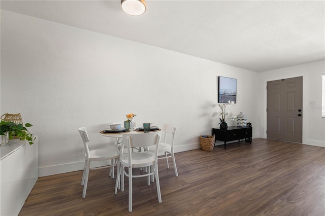 dining room with dark hardwood / wood-style flooring