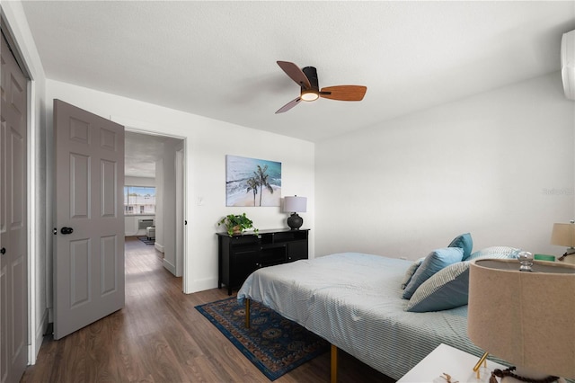 bedroom featuring dark wood-type flooring, ceiling fan, and a closet