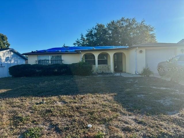 view of front of home featuring a garage and a front lawn