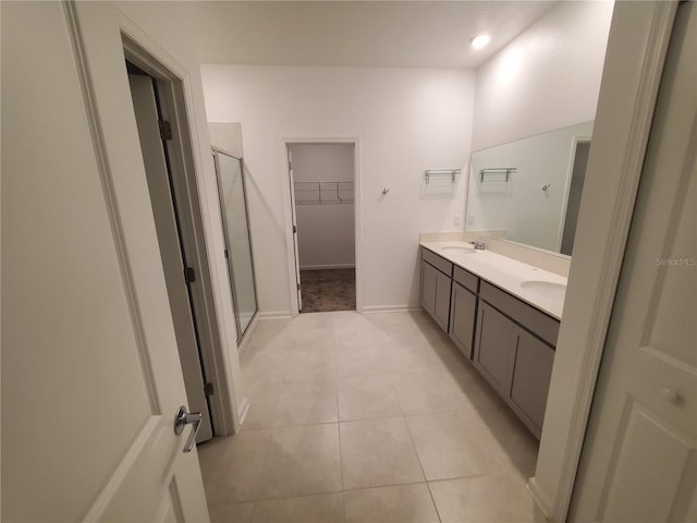 bathroom featuring vanity, tile patterned floors, and a shower with shower door