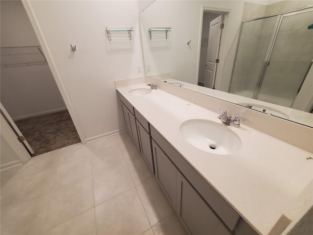 bathroom featuring vanity, tile patterned floors, and a shower with shower door