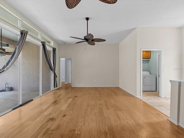 unfurnished living room with ceiling fan, washer / dryer, a textured ceiling, and light hardwood / wood-style floors