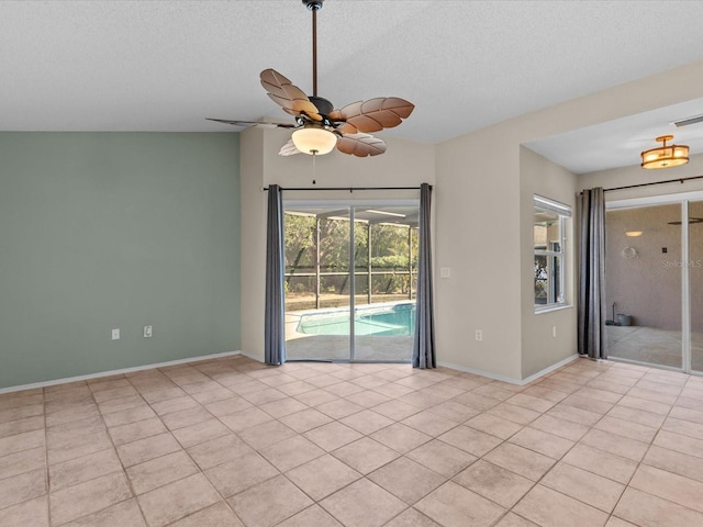 empty room featuring ceiling fan, a textured ceiling, and light tile patterned floors