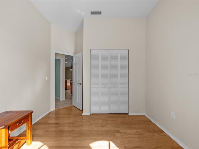 bedroom featuring light hardwood / wood-style floors and a closet