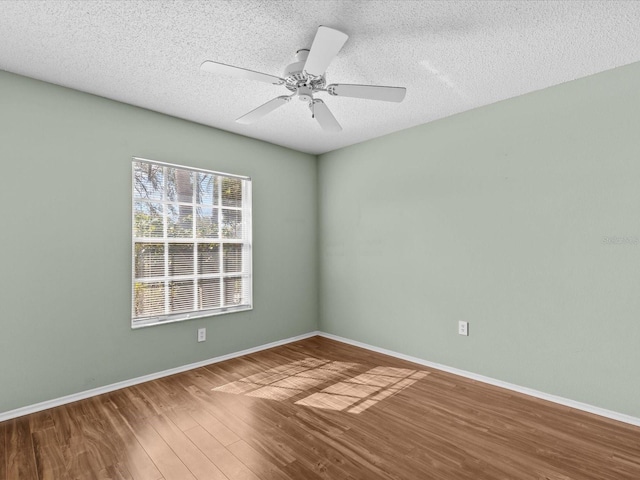 unfurnished room featuring hardwood / wood-style flooring, ceiling fan, and a textured ceiling