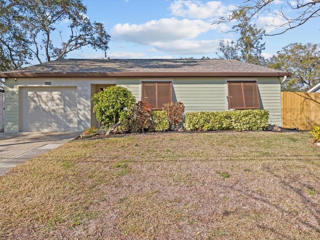 ranch-style house with an attached garage, driveway, a front yard, and fence