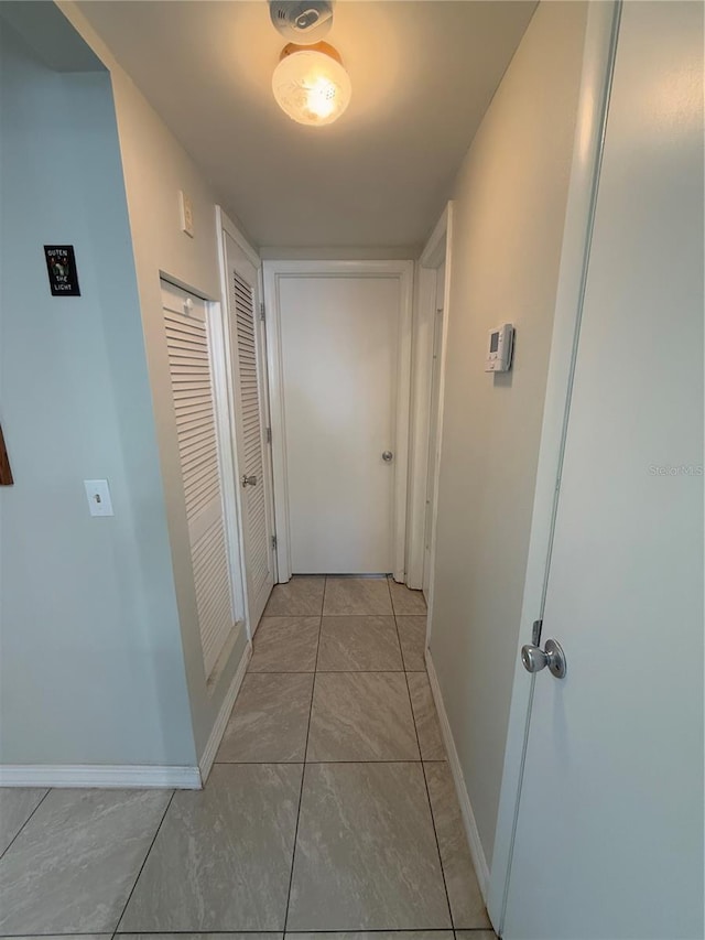 hallway featuring light tile patterned floors