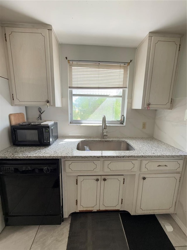 kitchen featuring sink, decorative backsplash, and black appliances