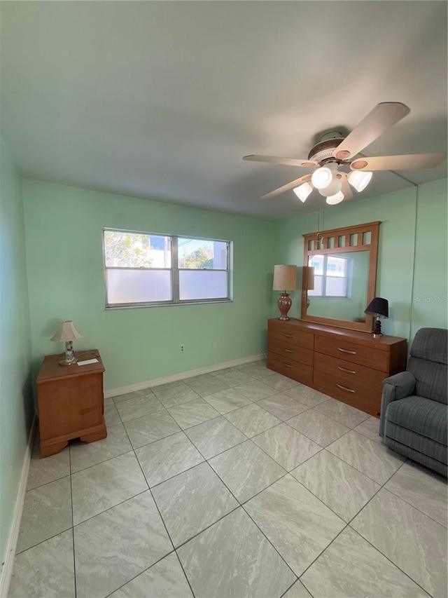 sitting room featuring a healthy amount of sunlight, light tile patterned floors, and ceiling fan