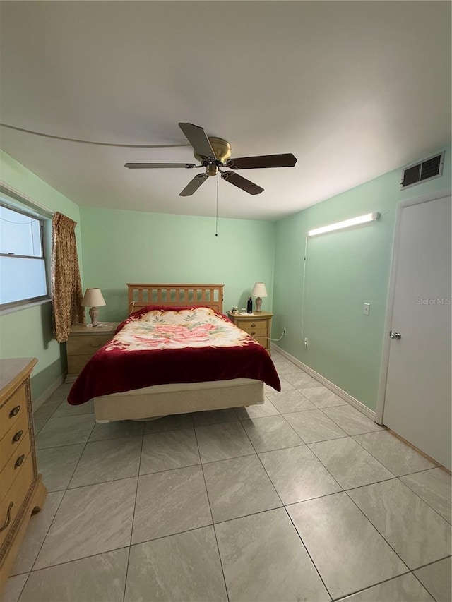 tiled bedroom with ceiling fan