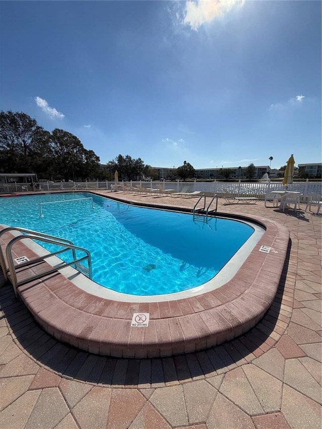 view of swimming pool featuring a patio area