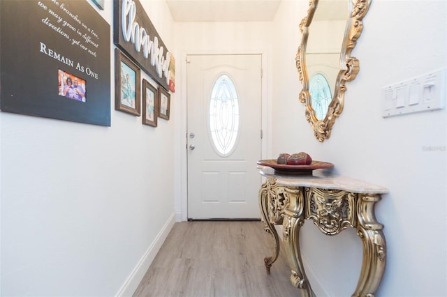 entryway featuring light wood-style floors and baseboards