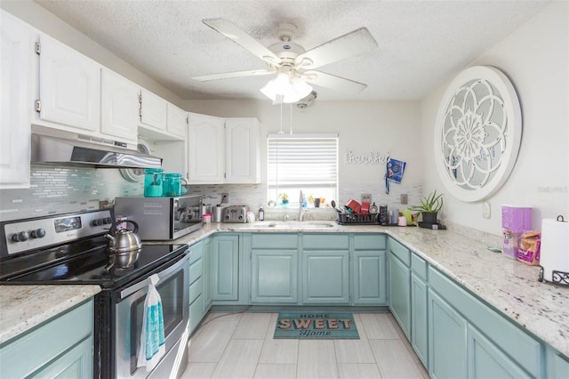 kitchen with stainless steel appliances, a sink, white cabinetry, and under cabinet range hood