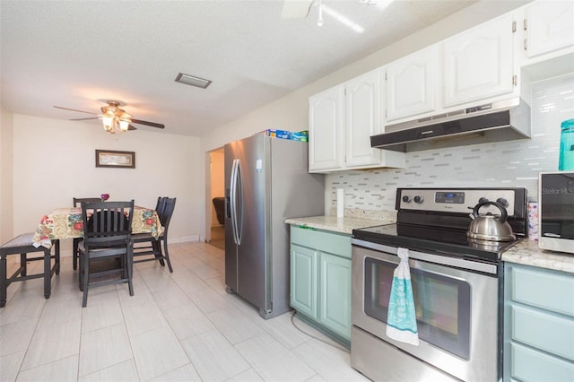 kitchen with appliances with stainless steel finishes, light countertops, under cabinet range hood, and white cabinetry