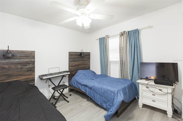 bedroom with ceiling fan and wood finished floors