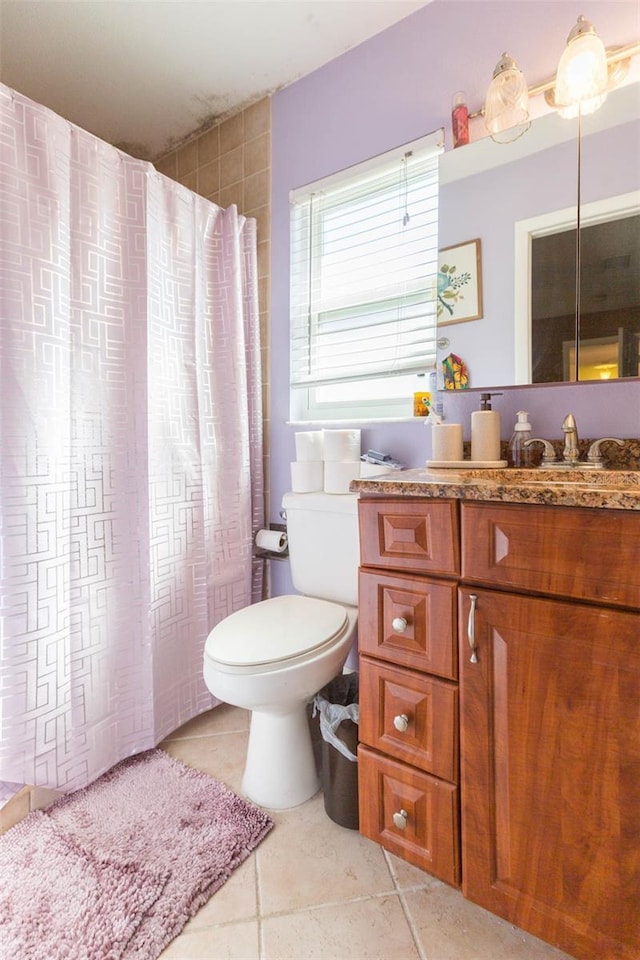 full bath with toilet, tile patterned flooring, and vanity