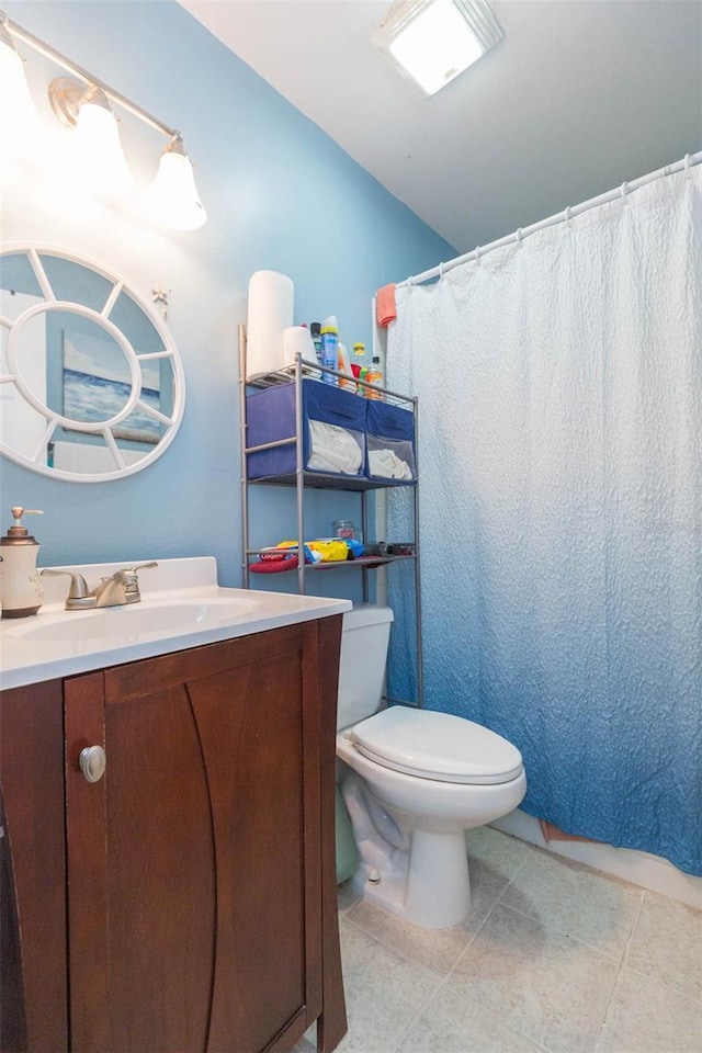 bathroom with vanity, tile patterned flooring, and toilet