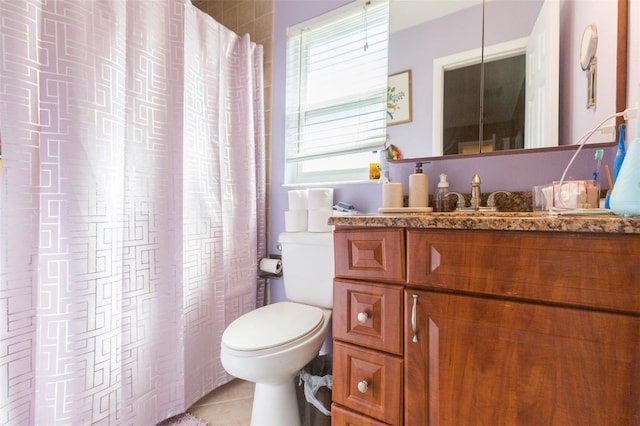 bathroom featuring toilet, tile patterned flooring, and vanity