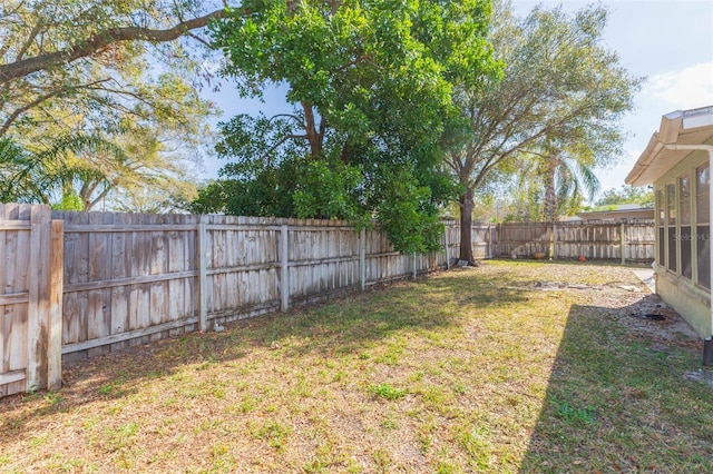 view of yard with a fenced backyard