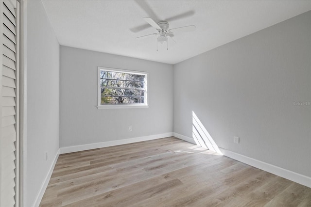 empty room with ceiling fan and light hardwood / wood-style flooring