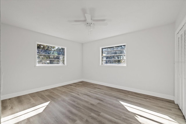 unfurnished bedroom featuring light hardwood / wood-style flooring, a closet, and ceiling fan