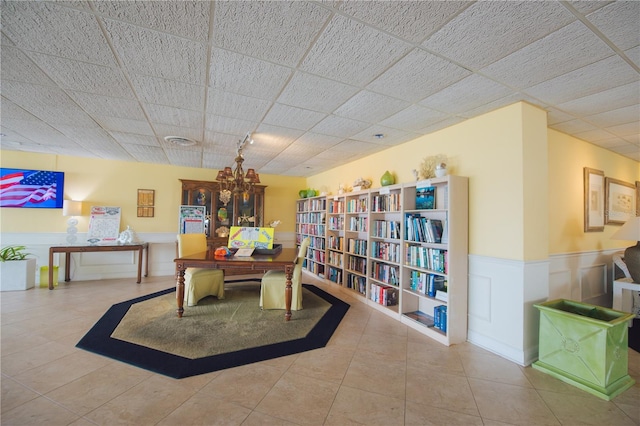 interior space with rail lighting, a drop ceiling, and tile patterned floors