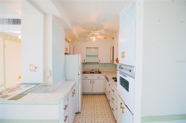 kitchen featuring ceiling fan, white appliances, sink, and white cabinets