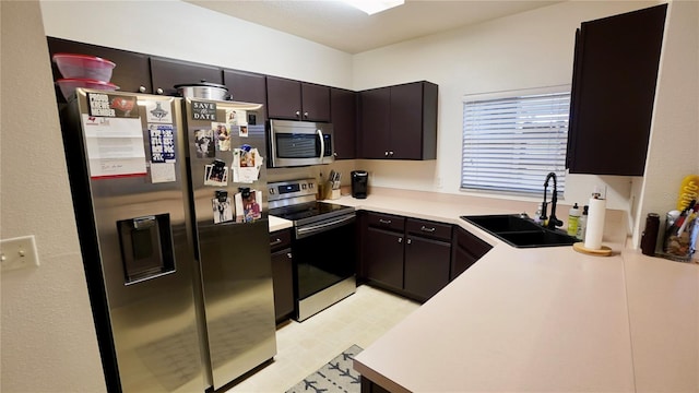 kitchen featuring sink, dark brown cabinets, and stainless steel appliances