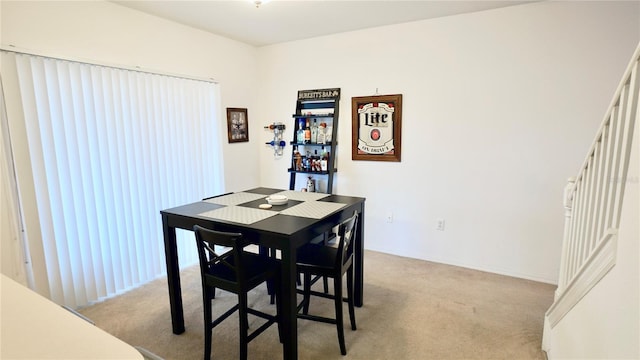 dining space with light colored carpet