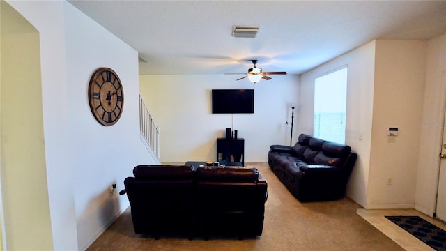 living room featuring ceiling fan and carpet